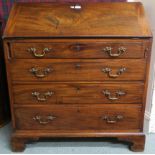 A Georgian mahogany four drawer fall front writhing bureau with fitted interior on bracket feet,