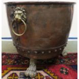 A 19th century copper and brass log bin on lions paw feet Condition Report: Available upon request