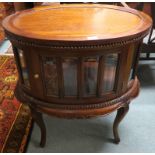 A 20th century mahogany glazed drinks cabinet with tray top on shaped supports Condition Report: