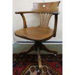 An early 20th century beech revolving desk chair, 83cm high Condition Report: Available upon