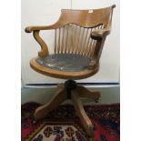 A 20th century oak spindle back revolving desk chair Condition Report: Available upon request