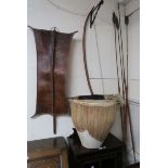 An assorted lot of tribal artifacts including a hide shield, bow, quiver with four arrows,four