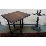 A cast iron stick stand and an oak barley twist occasional table (2) Condition Report: Available