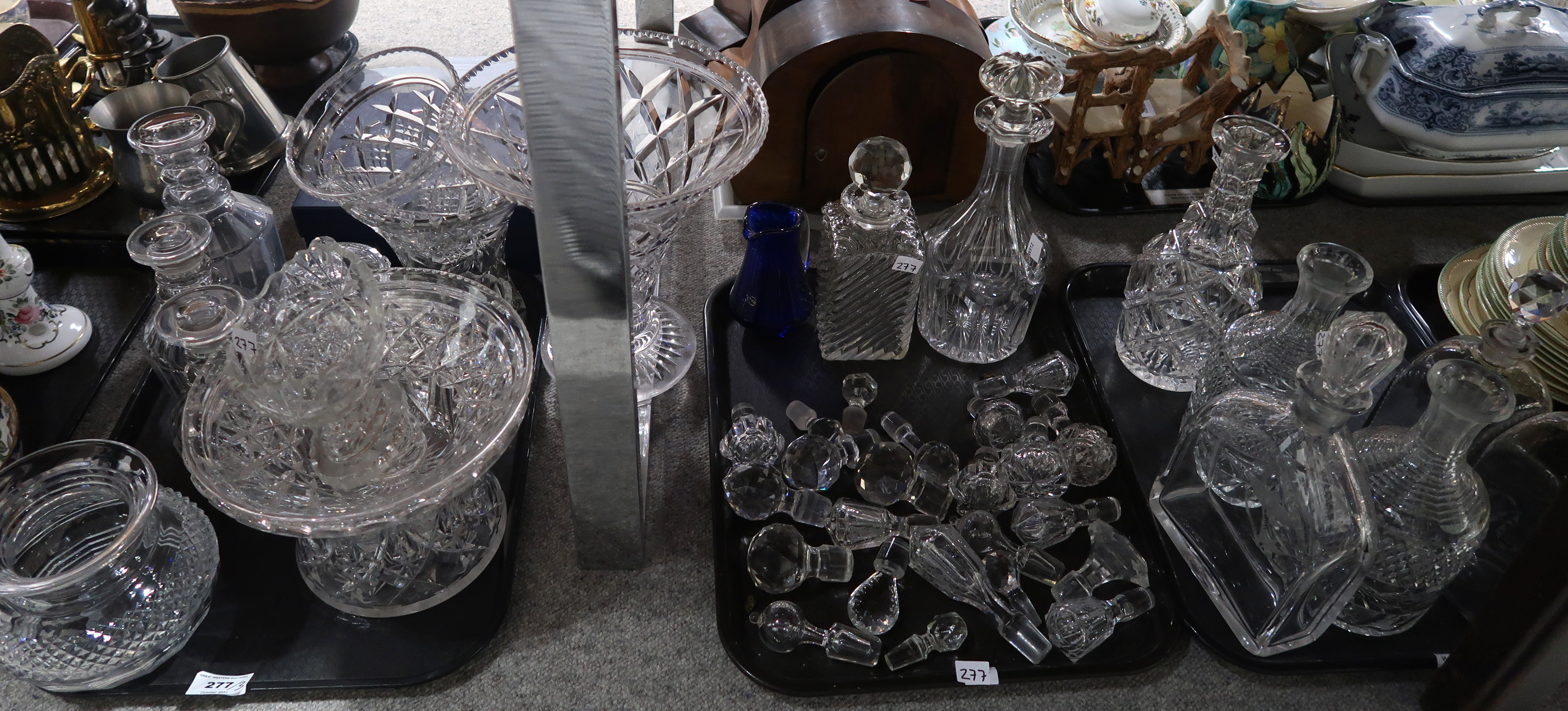 A lot comprising a selection of glassware including triple ring neck decanters, stoppers, fruit