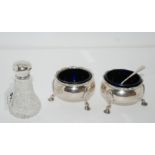 A lot comprising a pair of silver salts, London 1762, 163gms and a silver topped pepperette,