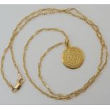 A 14k gold pendant, weight 2.7gms, on a fancy link 9ct chain, length 56cm, weight 5.2gms Condition