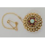 A 15ct gold Edwardian flower brooch set with pearls, rubies and an opal, diameter 2.2cm, weight 4.
