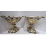 A pair of French porcelain baskets with painted floral decoration and gilding, 27cm high Condition