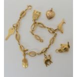 An 18k gold Italian made fancy link chain, with five attached 18k charms, loose one in bright yellow