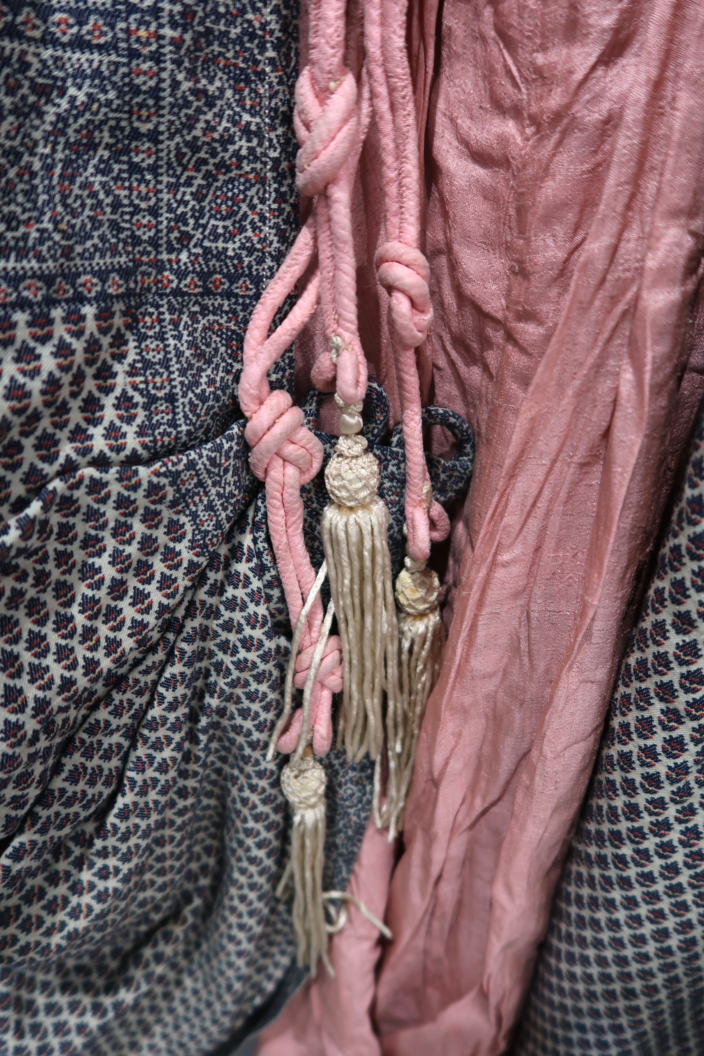 A cream ground embroidered Bedouin cloak with pink rope tassel fastenings and a pair of 1920s ruby - Image 3 of 4