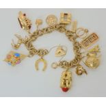 An extensive 9ct gold charm bracelet with unusual twist links and heart clasp, with eight 9ct