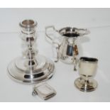A lot comprising a silver candlestick, London 1983, a cream jug, Birmingham 1914, a toothpick holder