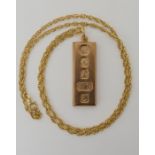 A 9ct gold ingot pendant dated Sheffield 1979, length with bail 5cm, with a yellow metal rope