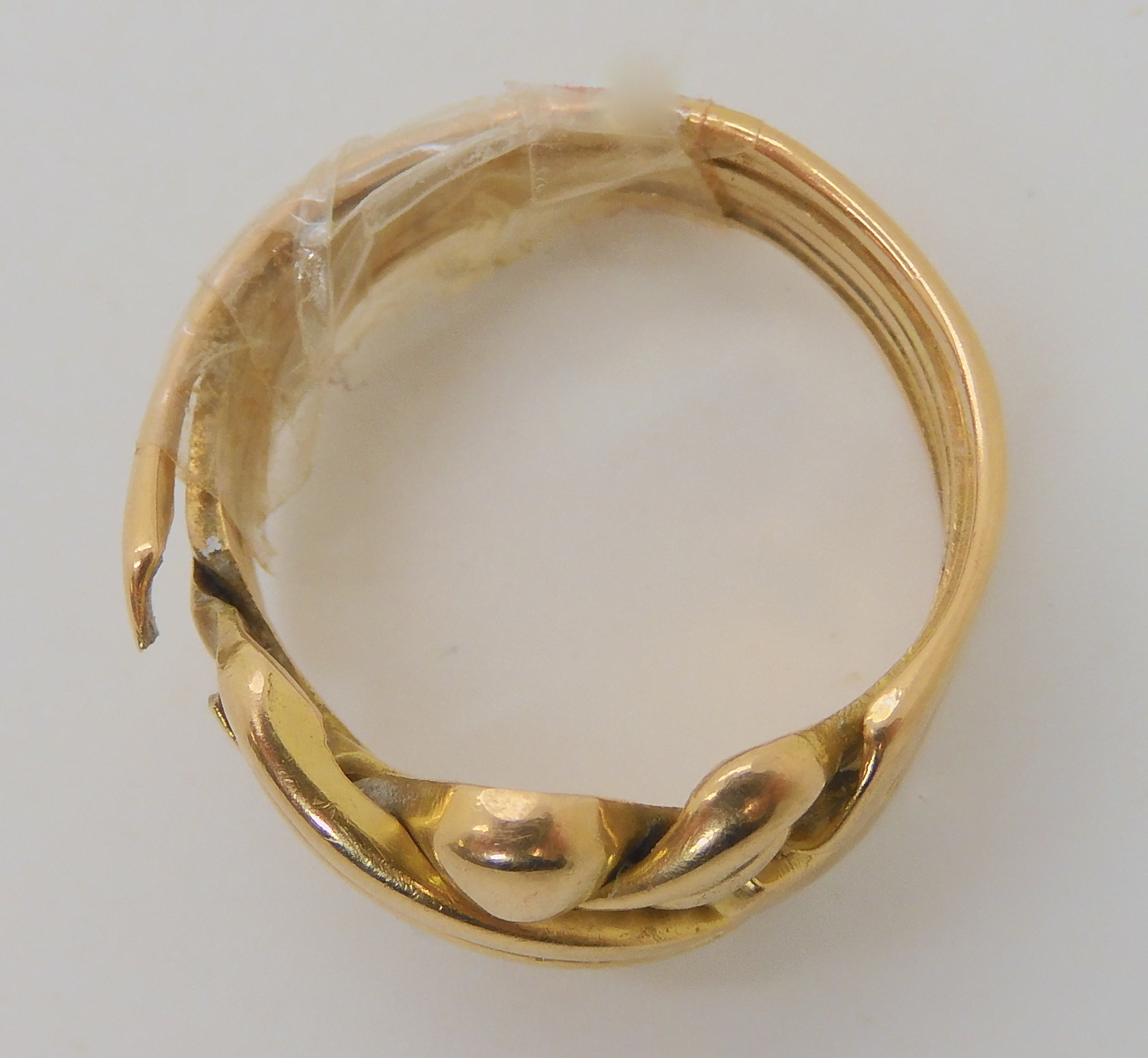 A bright yellow metal puzzle ring, weight 10.9gms Condition Report: The ring is selotaped together - Image 2 of 2