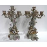 A pair of continental porcelain cherub decorated candelabras, 36cm high Condition Report: One is
