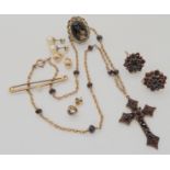 A gilded white metal garnet cross on a yellow metal chain with similar earrings, a 9ct pearl bar