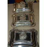 A pair of silver plated entree dishes and covers, 30.5 x 24cm and a single entree dish and cover