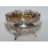A silver rosebowl, the base stamped 800, the rim with pierced decoration, the half spiral lobed body