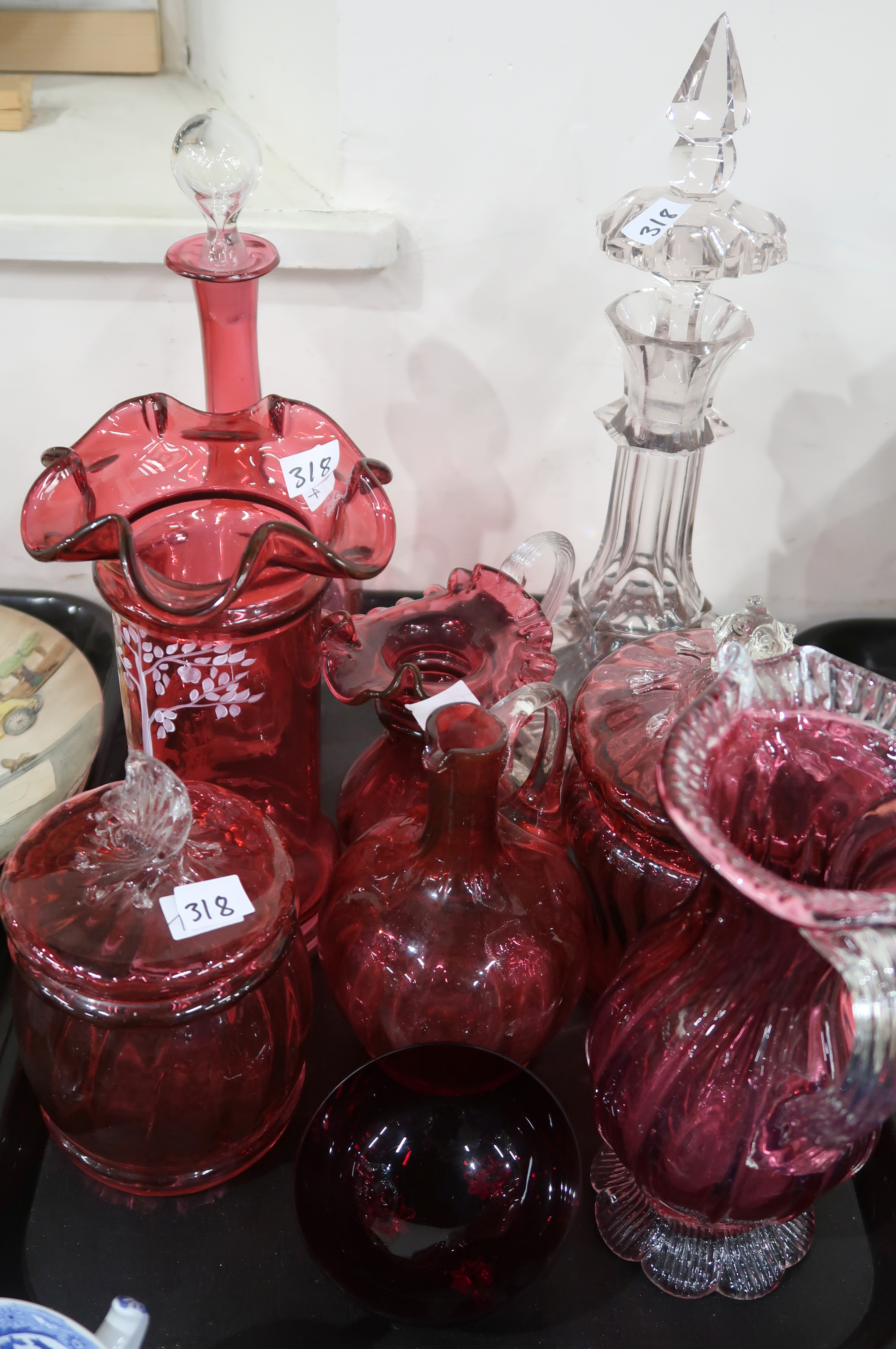 A selection of cranberry glass including a Mary Gregory style vase hand painted by S. Stephens,