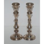 A pair of silver candlesticks, Birmingham 1976 with fixed sconces and knopped stems, 27cm high