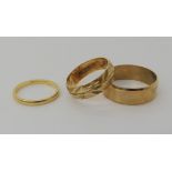 An 18ct gold wedding ring size J, weight 1.5gms, together with two 9ct examples sizes N1/2 and S1/2,
