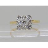 An 18ct and platinum 1930's nine stone diamond ring, size I1/2 (I for India) set with estimated