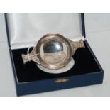 A cased silver quaich, Sheffield 1922? inscribed "Presented to Claude Thomson To Celebrate 50