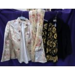 A lot comprising a cream ground floral embroidered ladies jacket, two other embroidered examples,
