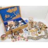 A cork landscape box full of vintage costume jewellery Condition Report: Not available for this lot