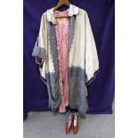 A cream ground embroidered Bedouin cloak with pink rope tassel fastenings and a pair of 1920s ruby