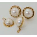 A pair of 14k gold mabe pearl earrings, and two yellow metal mounted mabe pearl pendants, weight