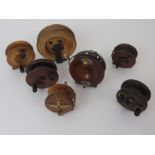 Seven various mahogany reels comprising 5in straight back, centre pin, 3in straight back, 3 1/2in