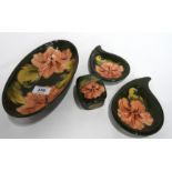 A collection of five Moorcroft Hibiscus pattern pieces including an oval bowl, dishes, trinket box