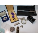 A silver money clip, silver medal, white-metal cased pocket watch etc Condition Report: Available