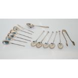 A lot comprising thirteen assorted silver coffee spoons and a pair of silver tongs, 135gms Condition