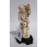 An ivory figure of a man and monkey Condition Report: Available upon request