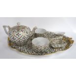 A Herend bachelor teaset comprising two cups, one saucer, milk jug, sugar dish and teapot on tray,