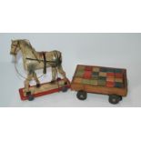 A box of miscellaneous including wooden horse and cart, tri-ang crane (def) building etc Condition