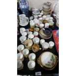 A large selection of demitasse cups and saucers including a set of lady artists hand painted