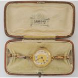 A 9ct ladies vintage watch and strap, retailed by Harrods, London. Hallmarked with London import