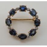 A 9ct gold sapphire and diamond circle brooch, diameter 2.3cm, sapphires approx 5.3mm x 4mm,