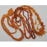 Four strings of amber beads, an amber brooch and a pair of earrings, weight combined 223.9gms