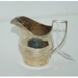 A silver cream jug, rubbed Chester marks, 10cm high, 127gms Condition Report: Available upon