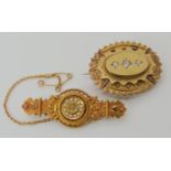 Two 15ct gold Victorian brooches, the oval locket back brooch is set with three old cut diamonds