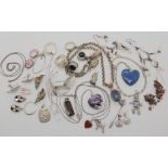 A silver mounted mystic quartz pendant, a lapis lazuli heart pendant, silver and white metal
