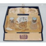 A cased three-piece silver and mother of pearl mounted glass condiment set, Birmingham 1928