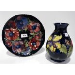 A Moorcroft anemone pattern plate, 26cm diameter, and a Hibiscus pattern vase Condition Report: