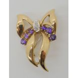 A 9ct amethyst and diamond bow brooch, dimensions 2.3cm x 3.4cm, weight 4.4gms Condition Report: