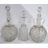 A pair of globular decanters with etched decoration of windmills, boats and vines and another etched