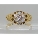 An 18ct gold diamond flower ring, set with estimated approx 0.35cts of old cut diamonds, size N,